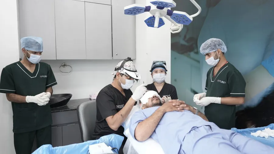 Medical professionals conducting a hair transplant procedure in a clinic
